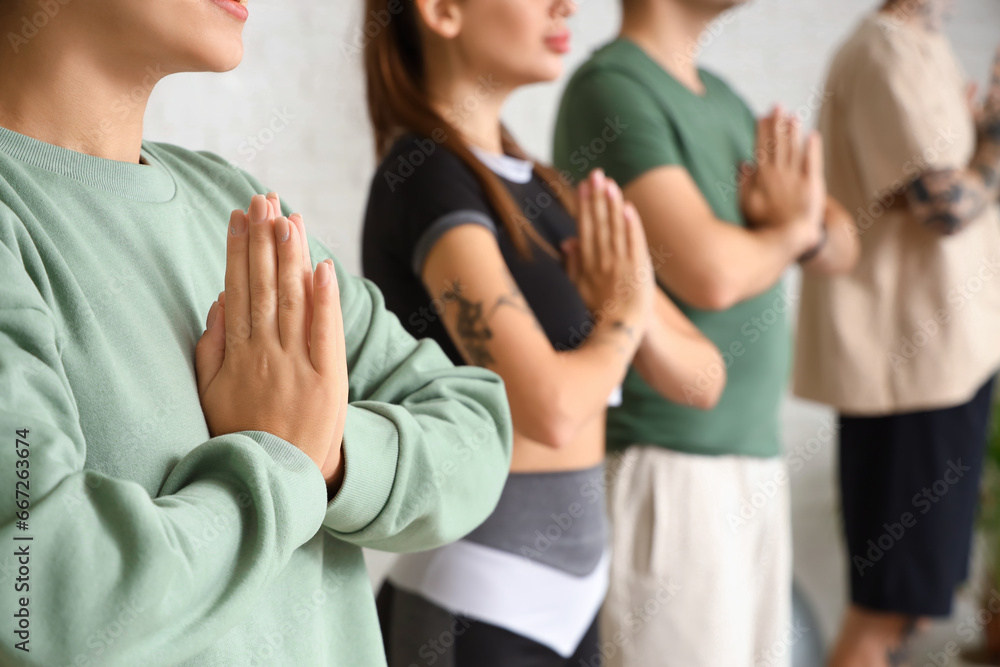 Fototapeta premium Sporty young woman meditating in gym, closeup
