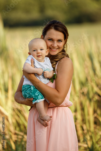 Mom with baby in her arms, in nature