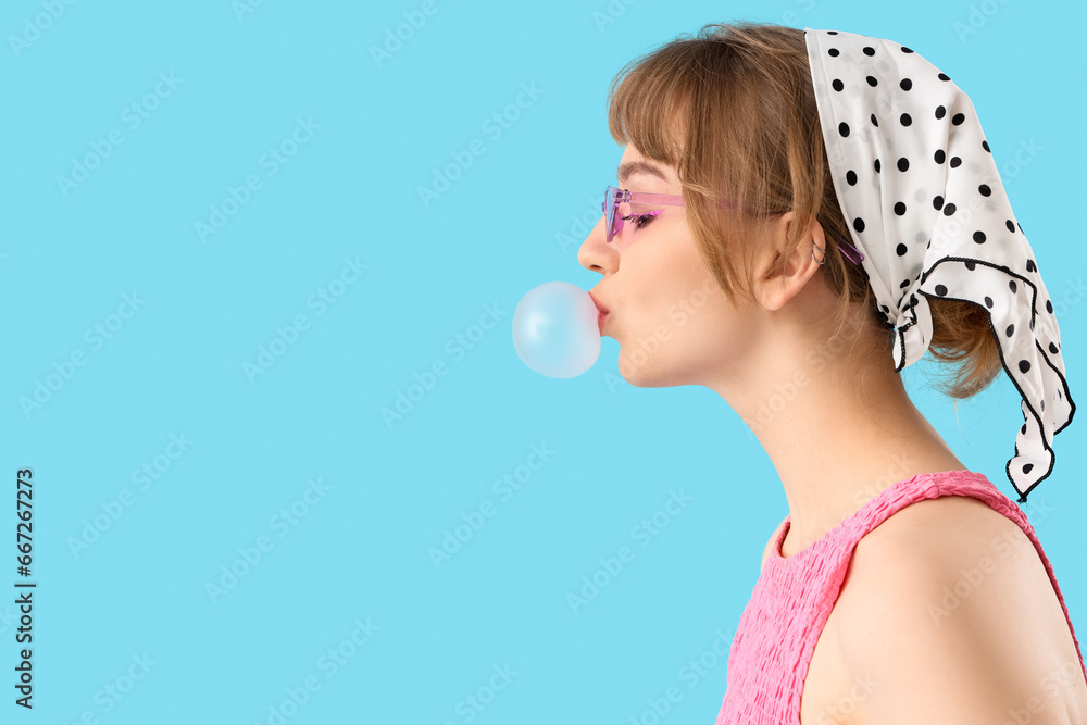 Beautiful young woman with chewing gum on blue background, closeup Beautiful young woman with chewing gum on blue background, closeup