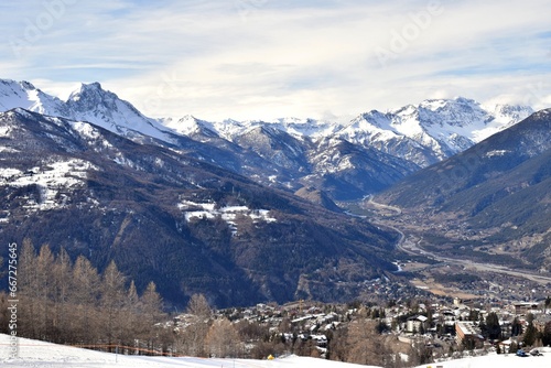 Elevated view of Susa Valley and snowy mountain peaks in Piedmont, Turin, Northern Italy. Located between the Graian Alps and the Cottian Alps. Taken from Sauze D'Oulx ski resort