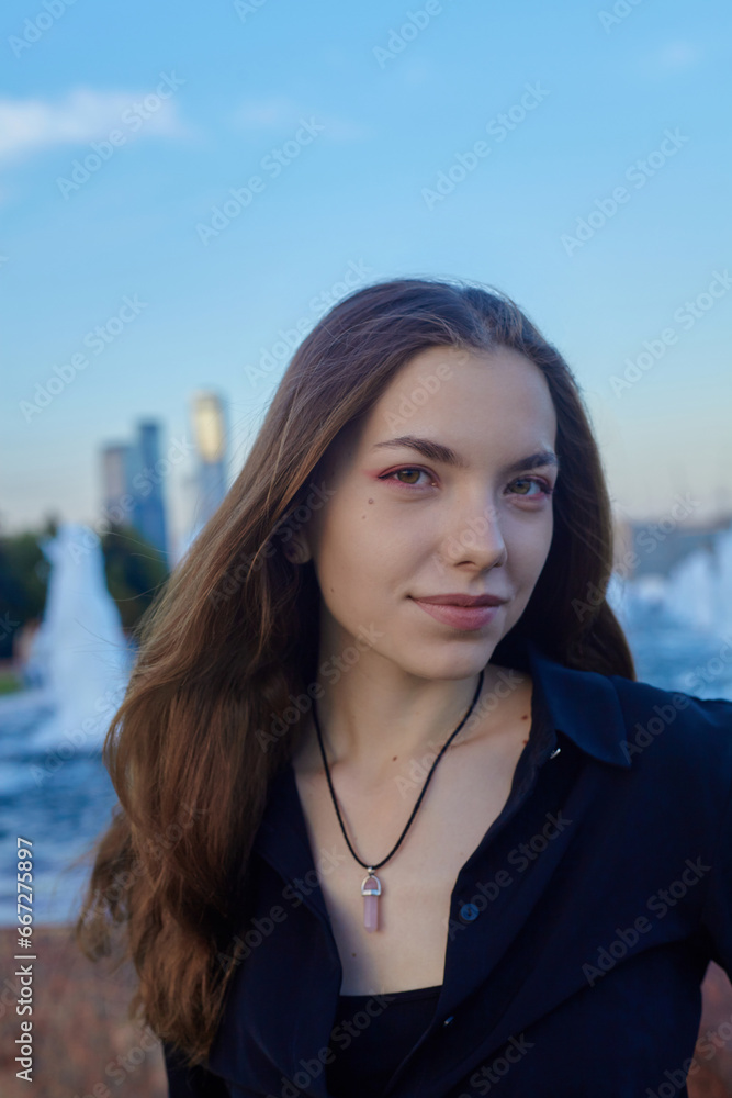 a happy woman walks through the city park happily smiling looking at the camera a happy woman walks through the city park happily smiling looking at the camera