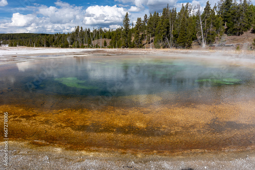 Beauty pool with steam rising from it in Yellowstone National Park