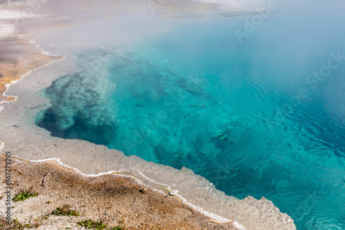 Brilliant blue thermal pool in West Thumb Basin in Yellowstone National Park