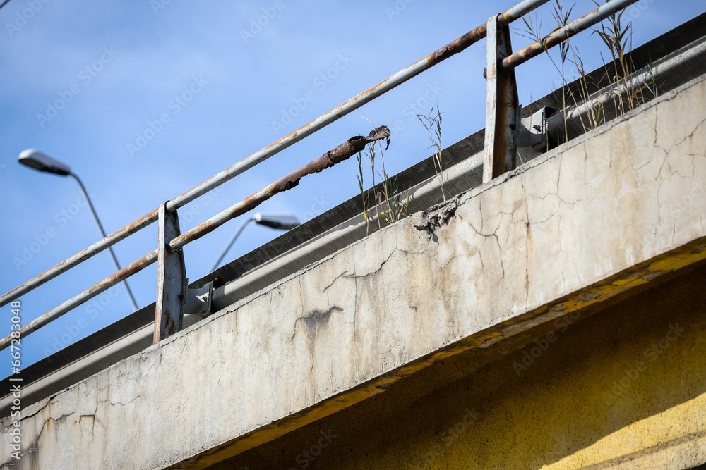 Cracks in the concrete structure of a bridge in a state of decay Cracks in the concrete structure of a bridge in a state of decay