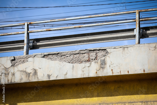 Cracks in the concrete structure of a bridge in a state of decay