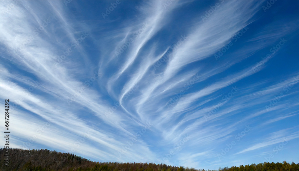 high white wispy cirrus clouds with cirri stratus in the blue sky