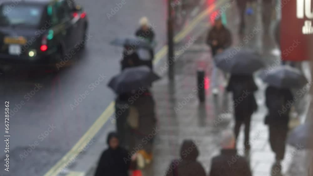 Crowd of people on the busy street under umbrella in rainy day,through the window view Crowd of people on the busy street under umbrella in rainy day,through the window view