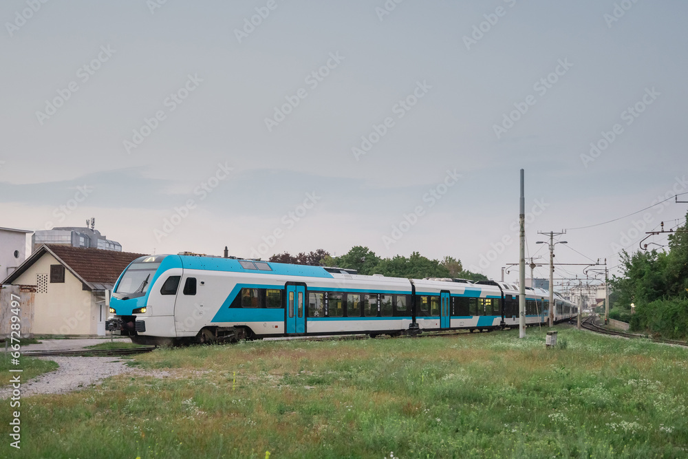 Long modern diesel train, triple units of blue and white train in early morning commute service in Ljubljana, Slovenia. Typical morning route to Kamnik. Long modern diesel train, triple units of blue and white train in early morning commute service in Ljubljana, Slovenia. Typical morning route to Kamnik.