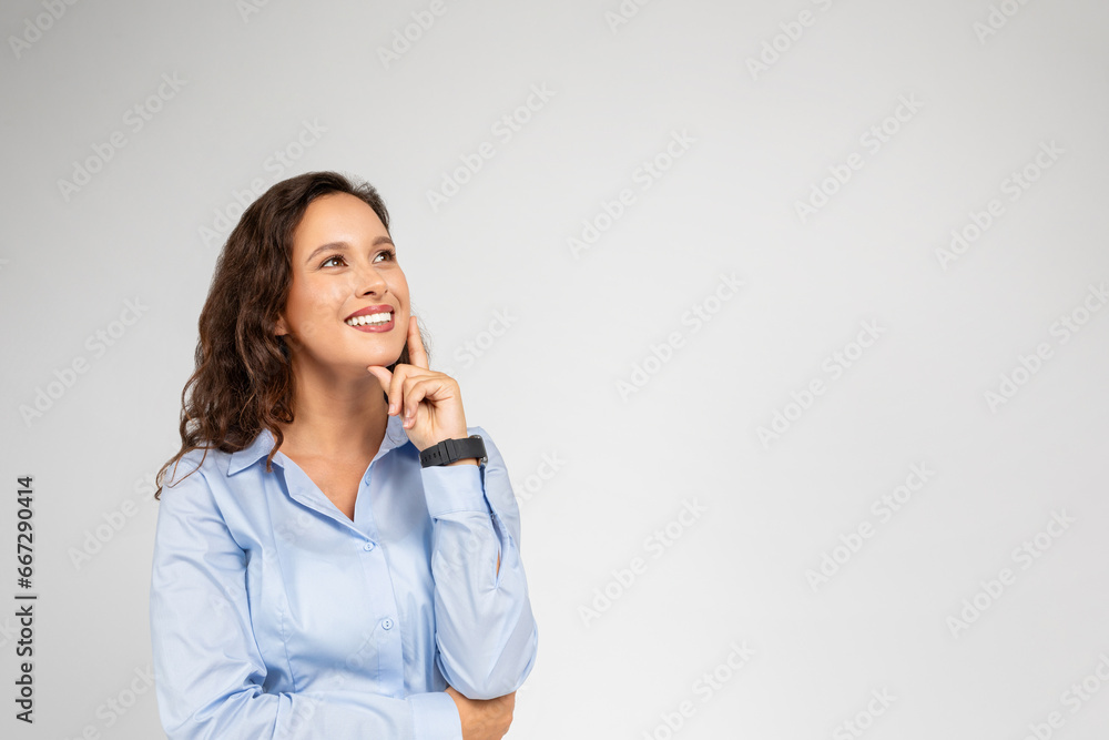 Glad pensive millennial caucasian business woman in formal wear thinks, look at empty space Glad pensive millennial caucasian business woman in formal wear thinks, look at empty space