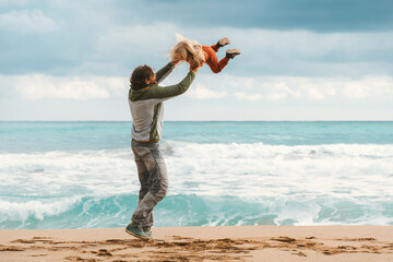 Father and daughter having fun family vacations lifestyle dad and child playing together outdoor walking on the beach Father's day holiday happiness candid emotions