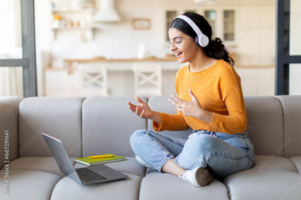 Video Call. Young Indian Woman In Headphones Teleconferencing On Laptop At Home Video Call. Young Indian Woman In Headphones Teleconferencing On Laptop At Home