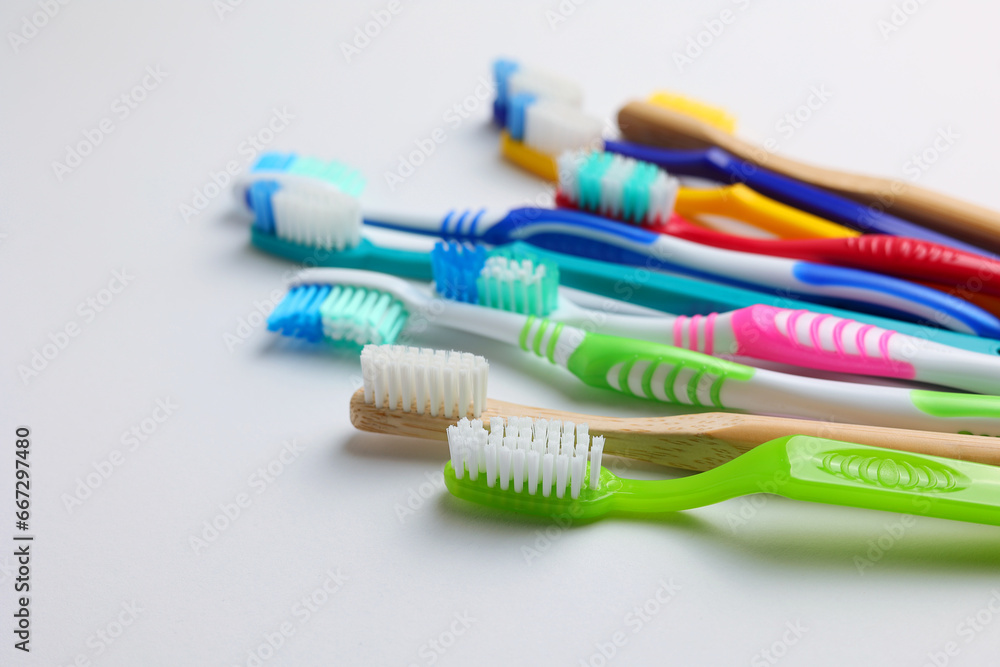 Different toothbrushes on a colored background. Dental care, oral health. Different toothbrushes on a colored background. Dental care, oral health.