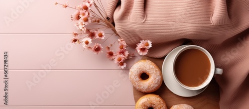 Autumn themed flat lay with sweater coffee donut and bag