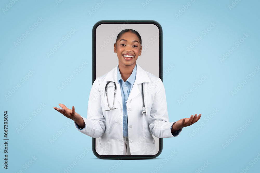Φωτογραφία Glad adult african american woman doctor hold free space on hands on big phone s