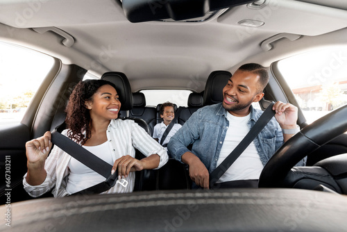 Happy african american family enjoying car ride together