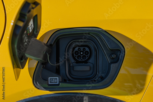 Charging port on yellow electric vehicle photo