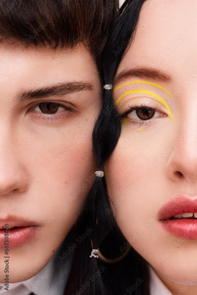 Macro fashion portrait of a young man and young woman faces together. Macro fashion portrait of a young man and young woman faces together.