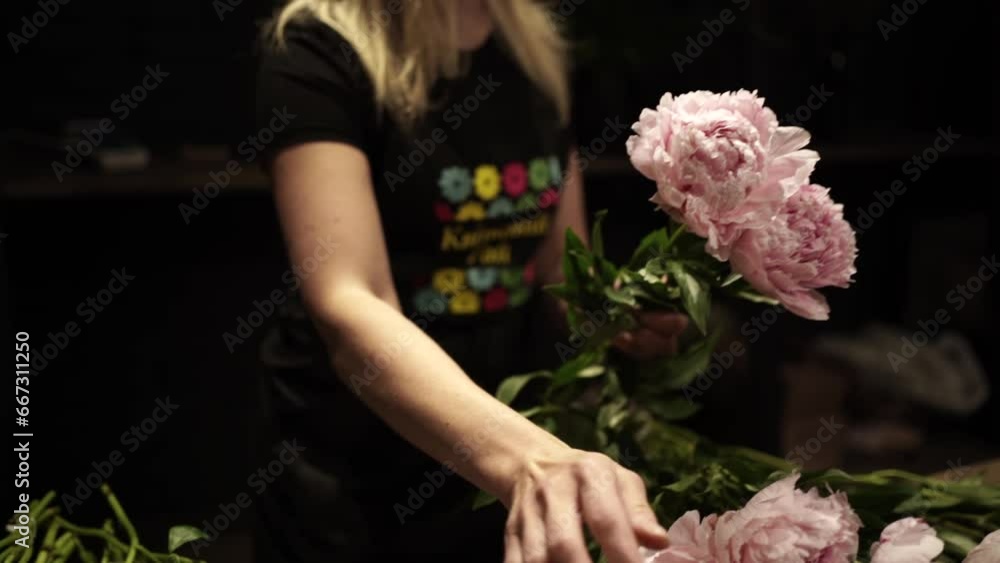 Florist making bouquet of flowers in flower shop in Lviv Florist making bouquet of flowers in flower shop in Lviv