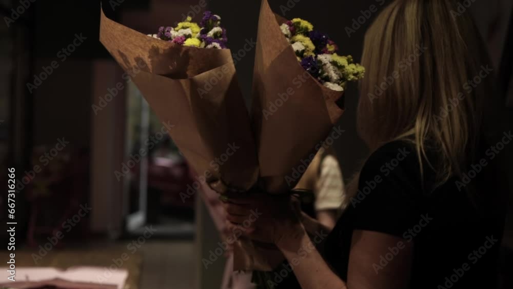 Florist making bouquet of flowers in flower shop in Lviv Florist making bouquet of flowers in flower shop in Lviv