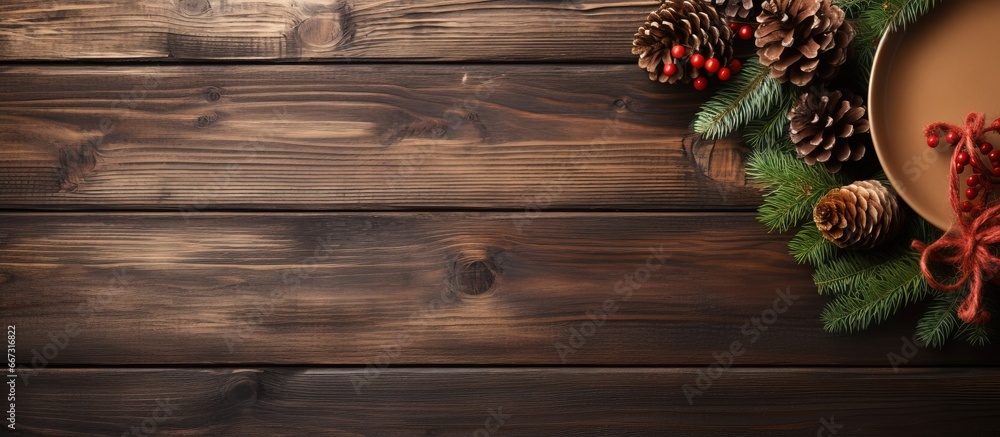 Holiday table setting with wooden table and pine tree branches Holiday table setting with wooden table and pine tree branches