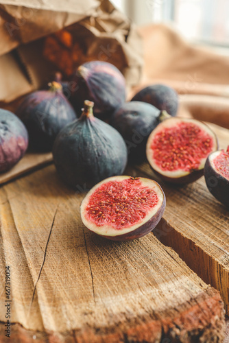 A few figs in a bowl on an old wooden background.