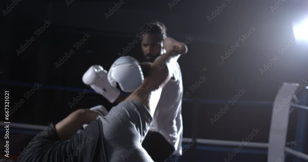 Muay Thai fighter lunching a kick to opponent in speed-ramp slow-motion. Rivals inside boxing ring fighting each other Muay Thai fighter lunching a kick to opponent in speed-ramp slow-motion. Rivals inside boxing ring fighting each other
