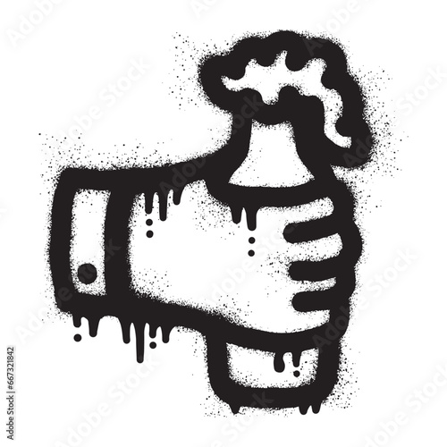 hand holding a beer bottle with black spray paint