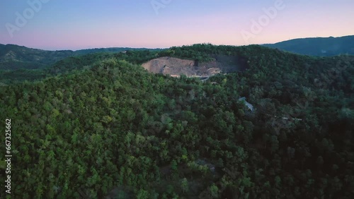 Sunset view of the forest in Siquijor island, Philippines. Slow aerial travelling. Drone view at dusk above Cangbangsa and Larena towns. Famous travel destination. photo