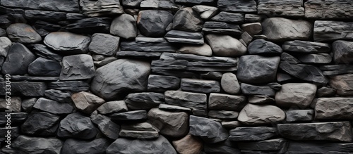 Texture of a wall made of granite rocks in black and white hues