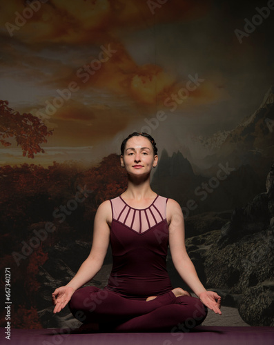 girl meditates doing yoga on a dark background