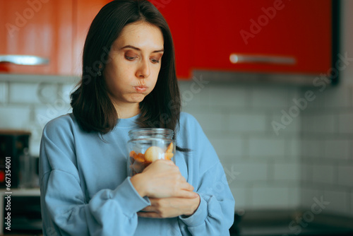 Craving Woman Breaking her Diet Stealing Cookies. Funny greedy girl snacking in secret eating many biscuits
