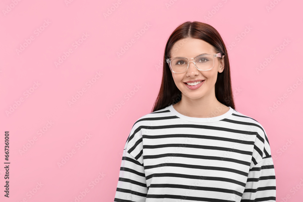 Smiling woman in stylish eyeglasses on pink background. Space for text Smiling woman in stylish eyeglasses on pink background. Space for text