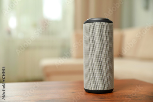 Portable bluetooth speaker on wooden table indoors, space for text. Audio equipment