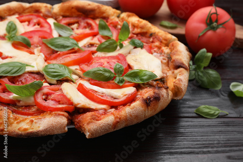 Delicious Caprese pizza on wooden table, closeup