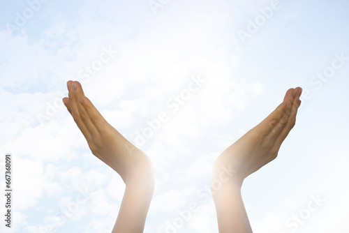 Feeling freedom. Woman reaching for sky on sunny day, closeup of hands Space for text