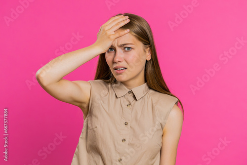 Face palm. Shame on you. Upset Caucasian young woman making face palm gesture, feeling bored, disappointed in result, bad news, sorrowful. Unhappy girl isolated on pink studio background indoors © Andrii Iemelianenko