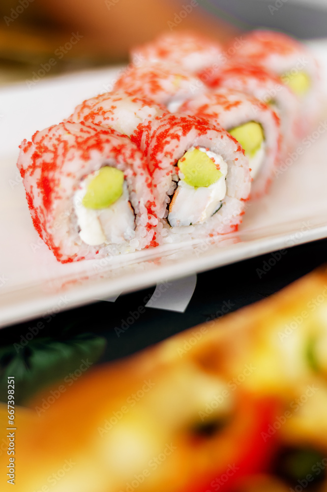 Close-up of red Philadelphia sushi rolls with eel on a blurred background, in a cozy restaurant. Japanese cuisine. Food, fast food, cafes Close-up of red Philadelphia sushi rolls with eel on a blurred background, in a cozy restaurant. Japanese cuisine. Food, fast food, cafes