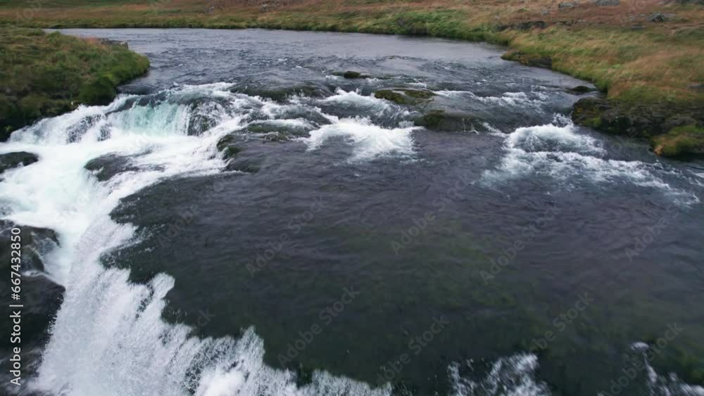 Aerial: Reverse reveal of Reykjafoss cascading waterfall that presents itself as a powerful cascade of water. It is a a hidden gem amidst Iceland's enchanting landscapes. Aerial: Reverse reveal of Reykjafoss cascading waterfall that presents itself as a powerful cascade of water. It is a a hidden gem amidst Iceland's enchanting landscapes.
