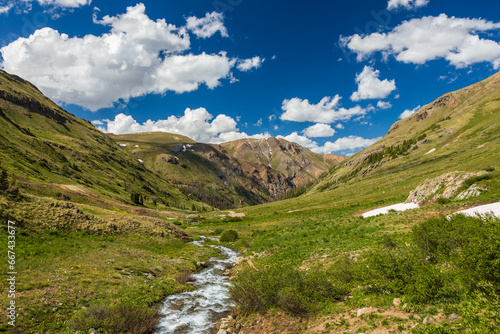 Fototapeta Naklejka Na Ścianę i Meble -  Mountain tundra valley with flowing river in the summer afternoon