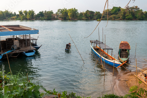 Narrow boats at small Don Det Island jetty beach and entry point 4000 Islands Champasak Province of southern Laos.