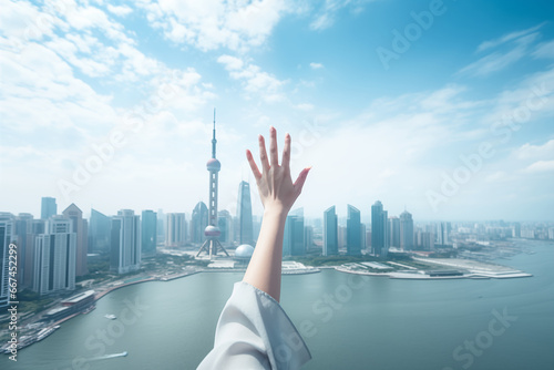 Close up of hand of businesswoman touching the sky with cityscape background photo