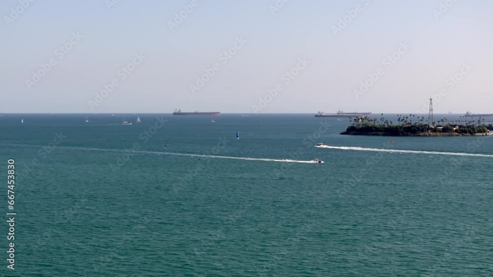 Aerial tracking shot of Speed boats Cruising by Kitesurfer In Long Beach coastline, California Aerial tracking shot of Speed boats Cruising by Kitesurfer In Long Beach coastline, California