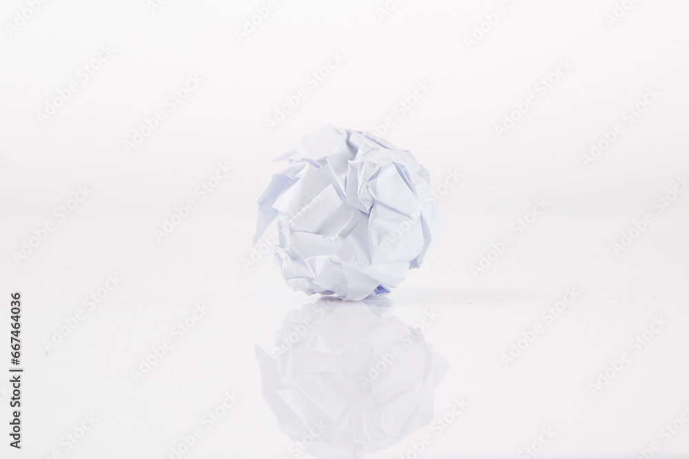 Close-up of crumpled ball of paper, on white background Close-up of crumpled ball of paper, on white background