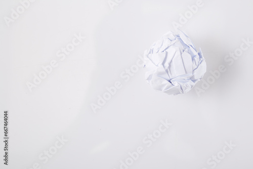Close-up of crumpled ball of paper  on white background