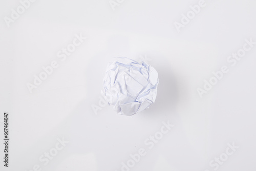 Close-up of crumpled ball of paper  on white background