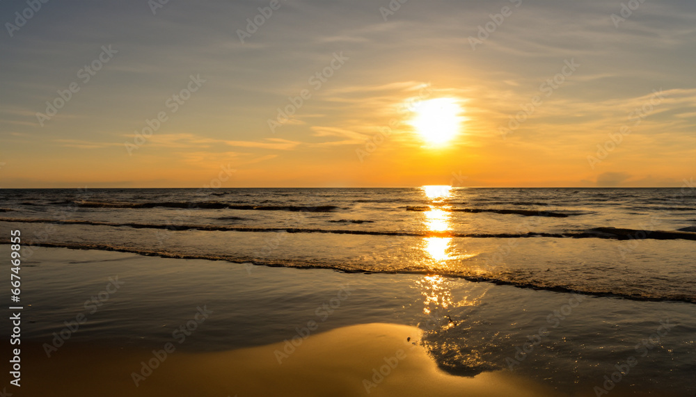 The sun is low over the water on the sea beach
