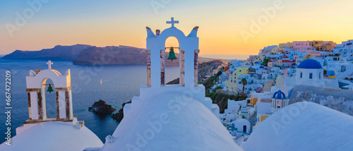 Oia Santorini Greece, a traditional Greek village in Santorini with whitewashed churches and blue domes at sunset 