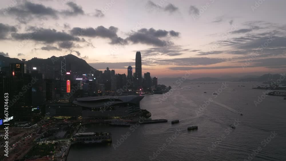 Rising drone shot over Wan Chai Exhibition Centre with Central financial district in backdrop after sunset. Rising drone shot over Wan Chai Exhibition Centre with Central financial district in backdrop after sunset.