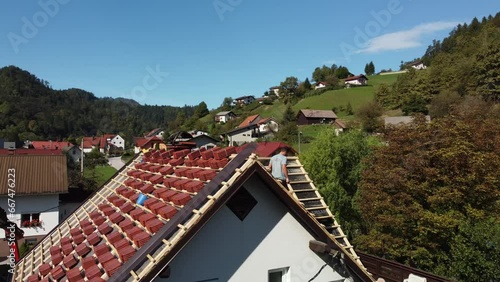Wallpaper Mural Worker walks down wooden beams across top of roof, red shingles stacked in preparation Torontodigital.ca