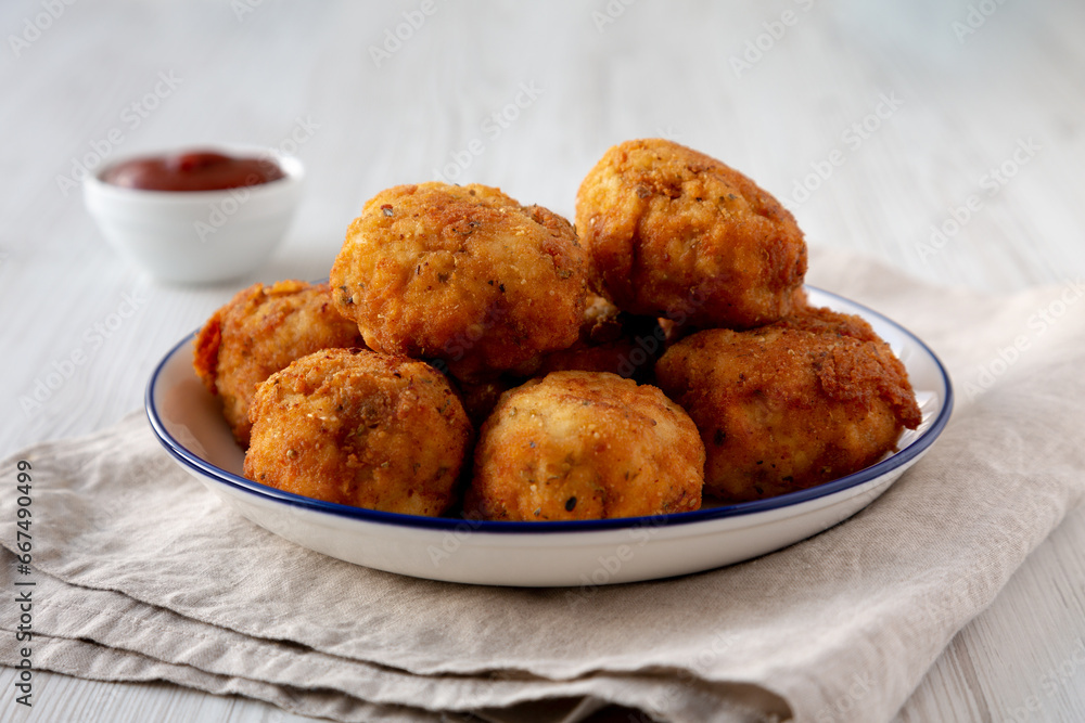 Homemade Cheesy Chicken Nuggets with Ketchup, side view. Homemade Cheesy Chicken Nuggets with Ketchup, side view.